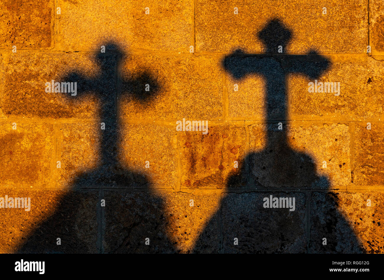 The silhouette of two crosses at sunset, concept of the catholic religion, faith and Christianity. Stock Photo