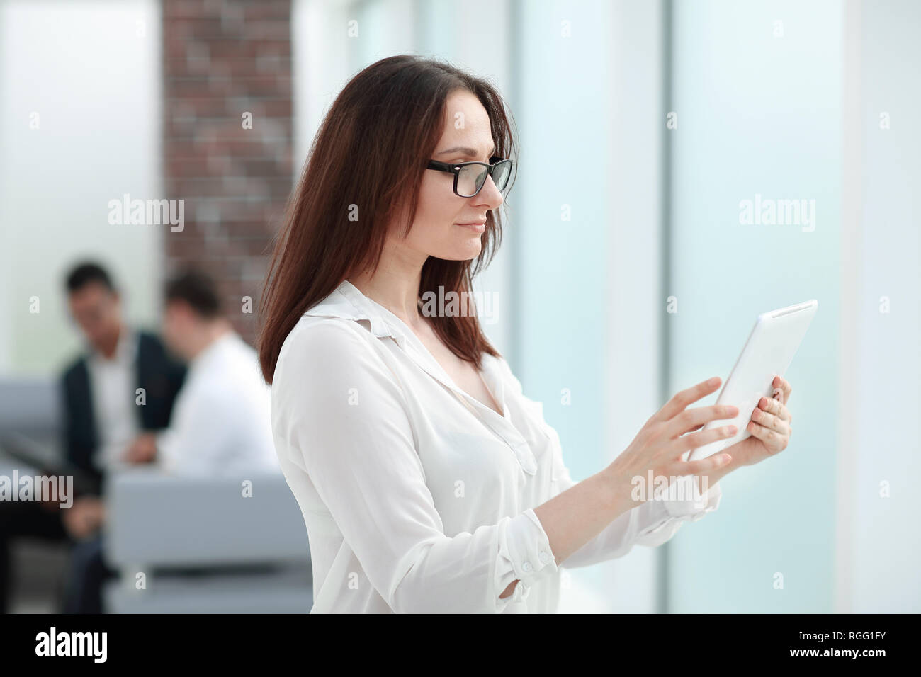 modern businesswoman reading a message on a digital tablet Stock Photo