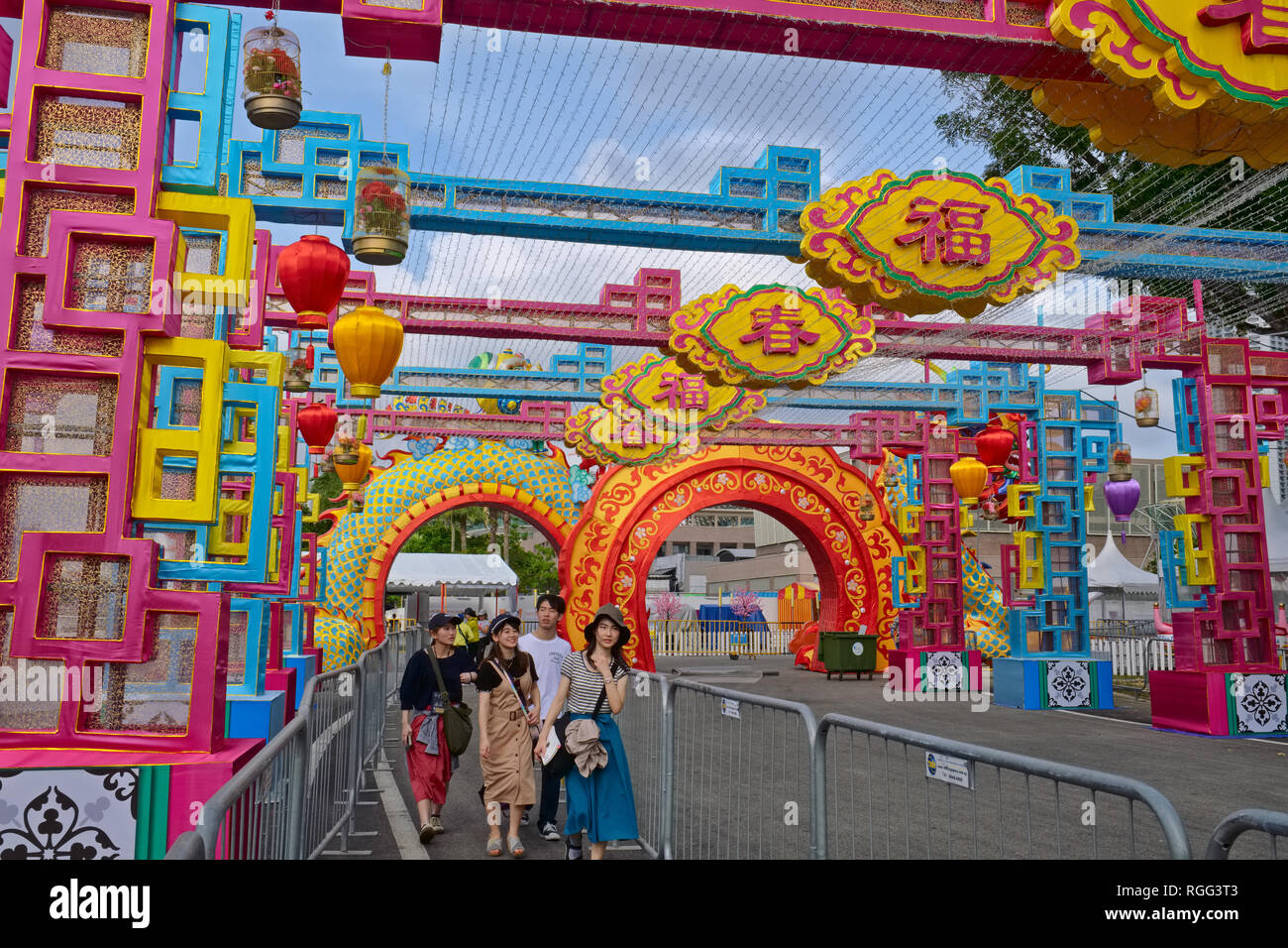Tourists enjoying Chinese New Year decorations (Year of the Pig) at Esplanade, Marina Bay, Singapore Stock Photo
