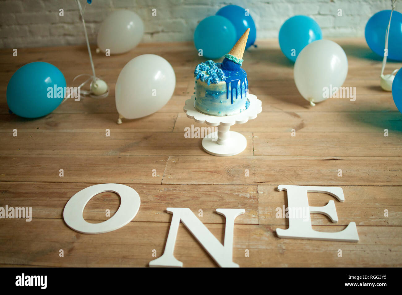 Decorations for one year birthday with a lot of blue and white balloons