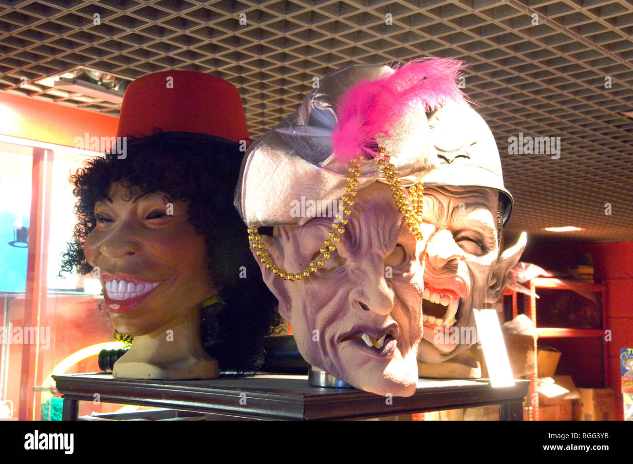 Three grotesque rubber face masks for sale in a magic shop Stock Photo