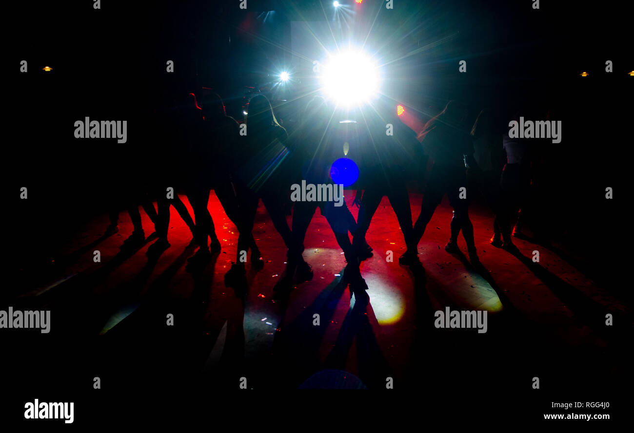 Pretty woman dancing in shadow and lights. Stock Photo
