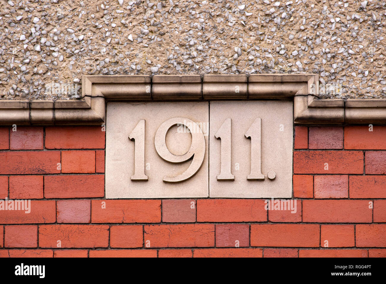 1911 lettering on outside wall Stock Photo