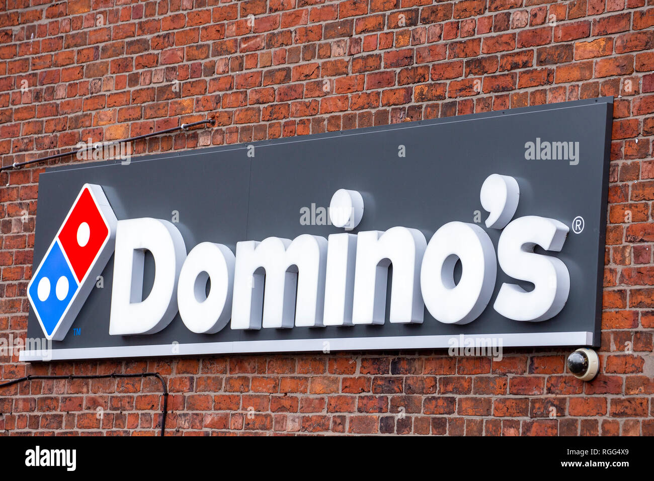 Domino's pizza sign on outside wall UK Stock Photo