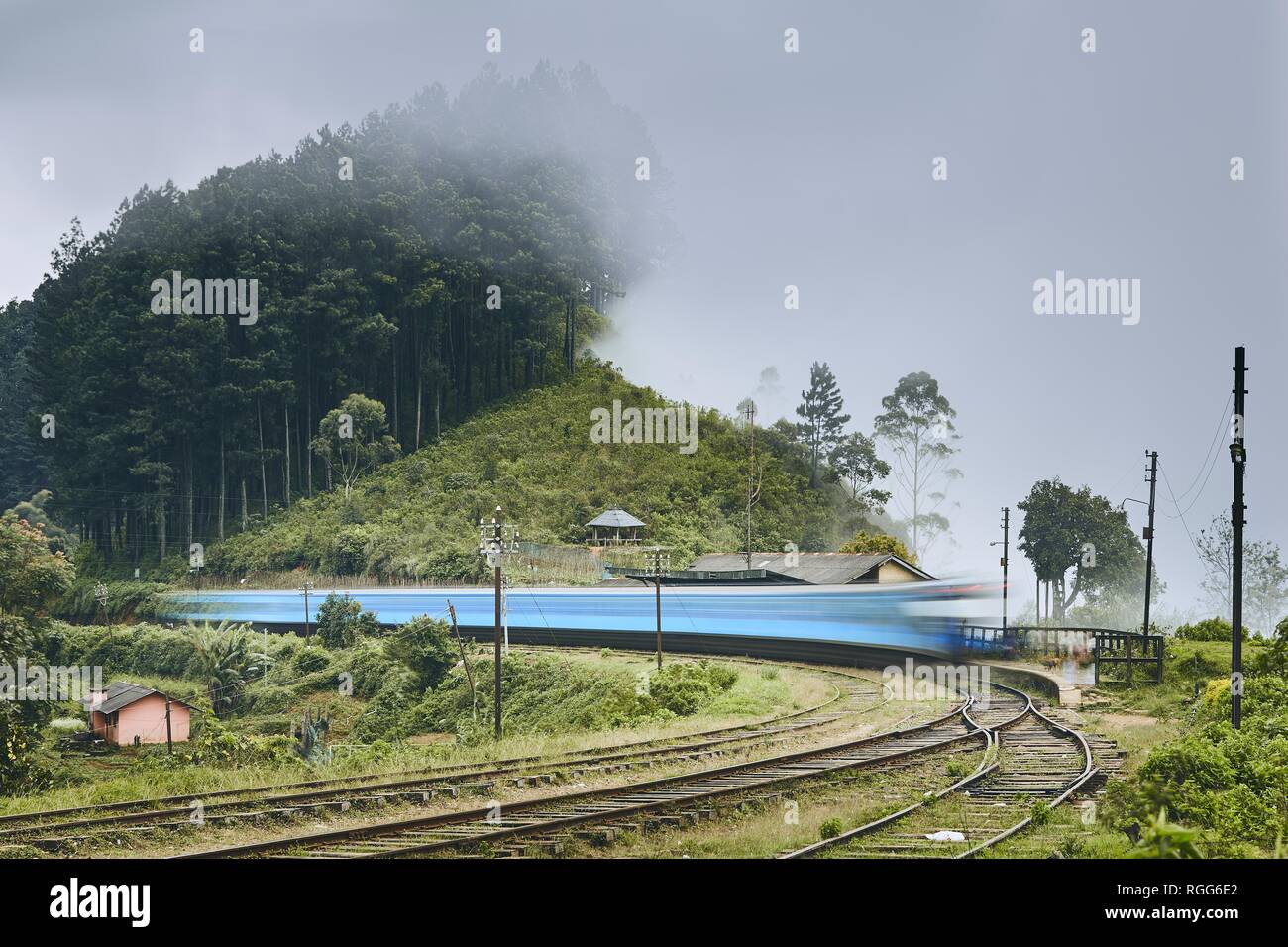 Passenger train on the move in mountains railroad station in Sri Lanka. Stock Photo