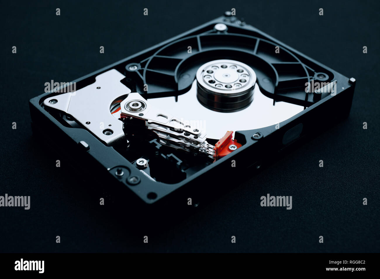 Hard drive assembly uncovered with arm read/write head and platters, Data storage equipment concepts. Stock Photo