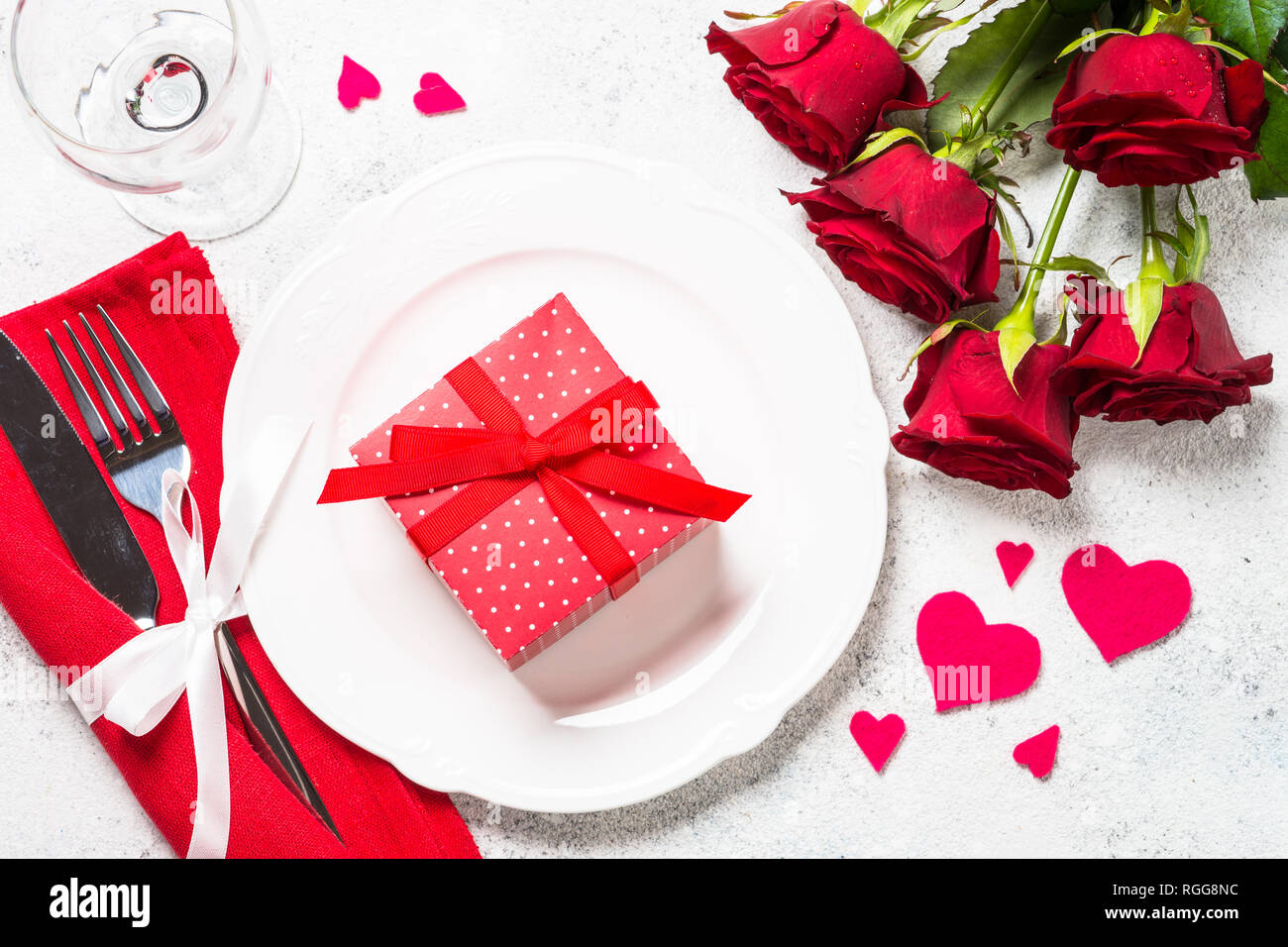 Valentines day table setting with plate, roses flower and present. Top ...