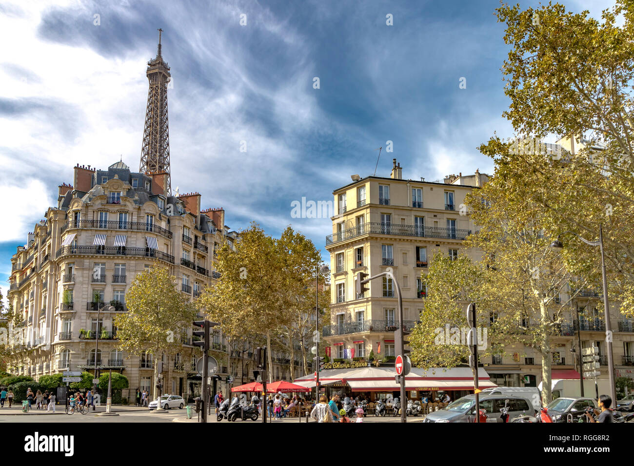 The Eiffel Tower rises above elegant Parisian apartment buildings with iron balconies in 7th arrondissement of Paris Stock Photo