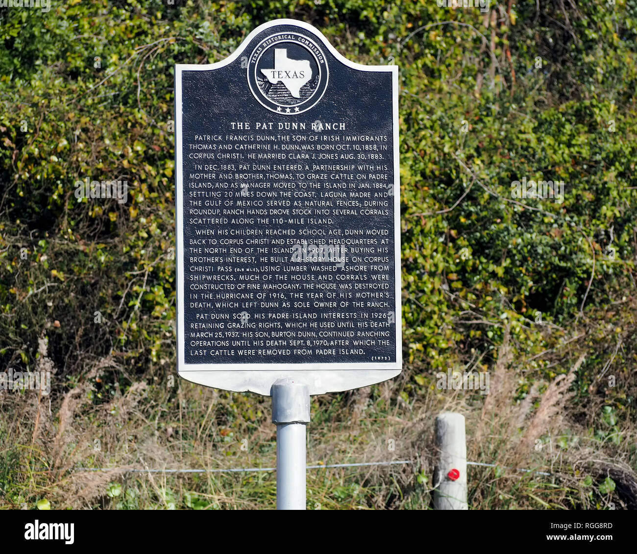 A Texas Historical Commission sign in Packery Channel County Park commemorates the Pat Dunn Ranch established in 1884 on Padre Island Texas USA. Stock Photo