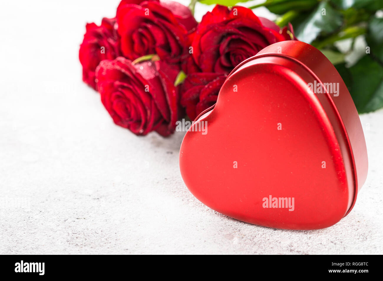 Valentines day background. Red rose and heart on white background. Stock Photo