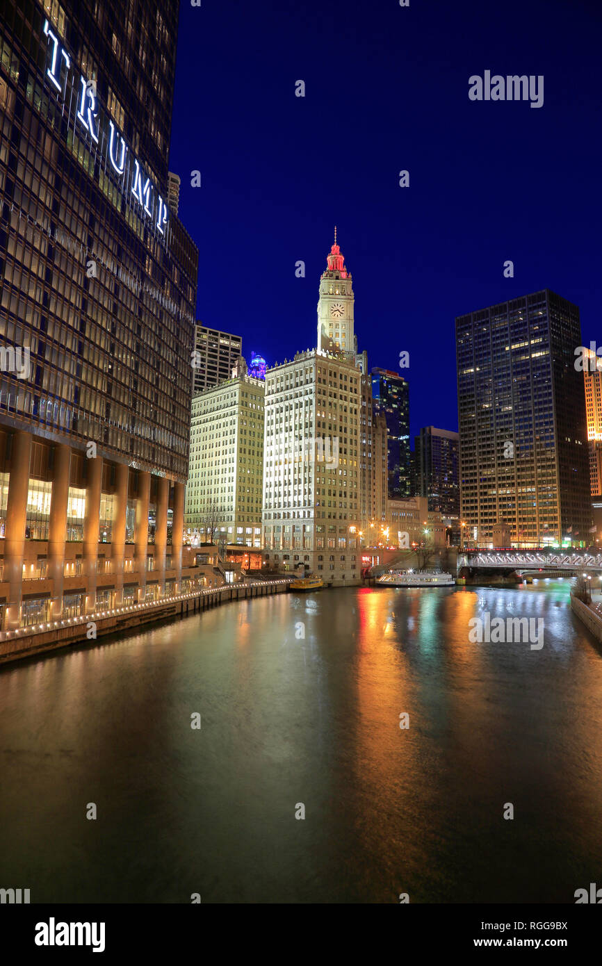 Night view of Chicago River with historical Wrigley Building in the background and Trump Hotel and Tower in foreground.Chicago.Illinois.USA Stock Photo