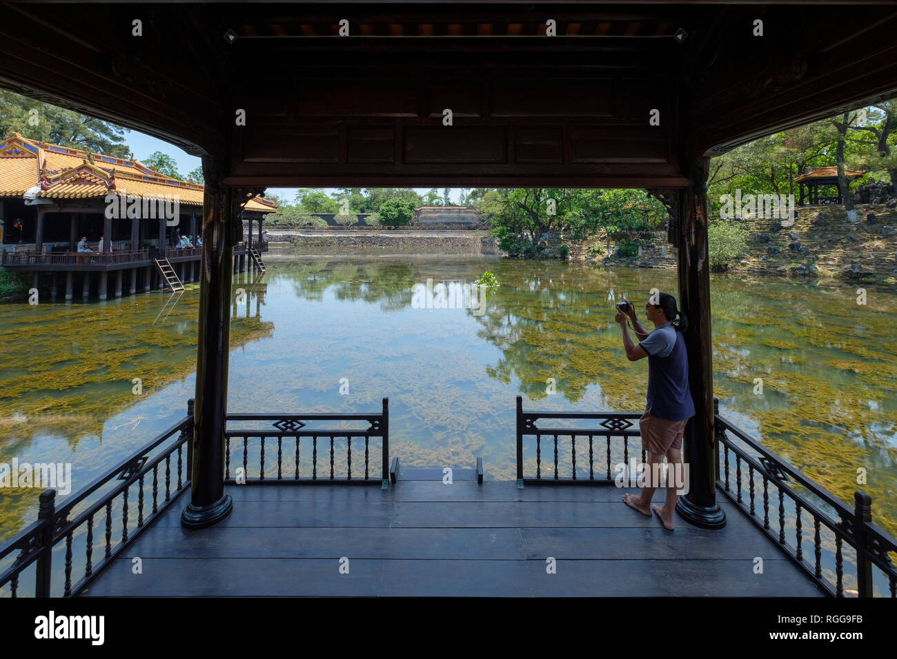 Western tourist taking pictures of the Xung Khiem pavilion at the Emperor Tu Duc tomb complex in Hue, Vietnam, Asia Stock Photo