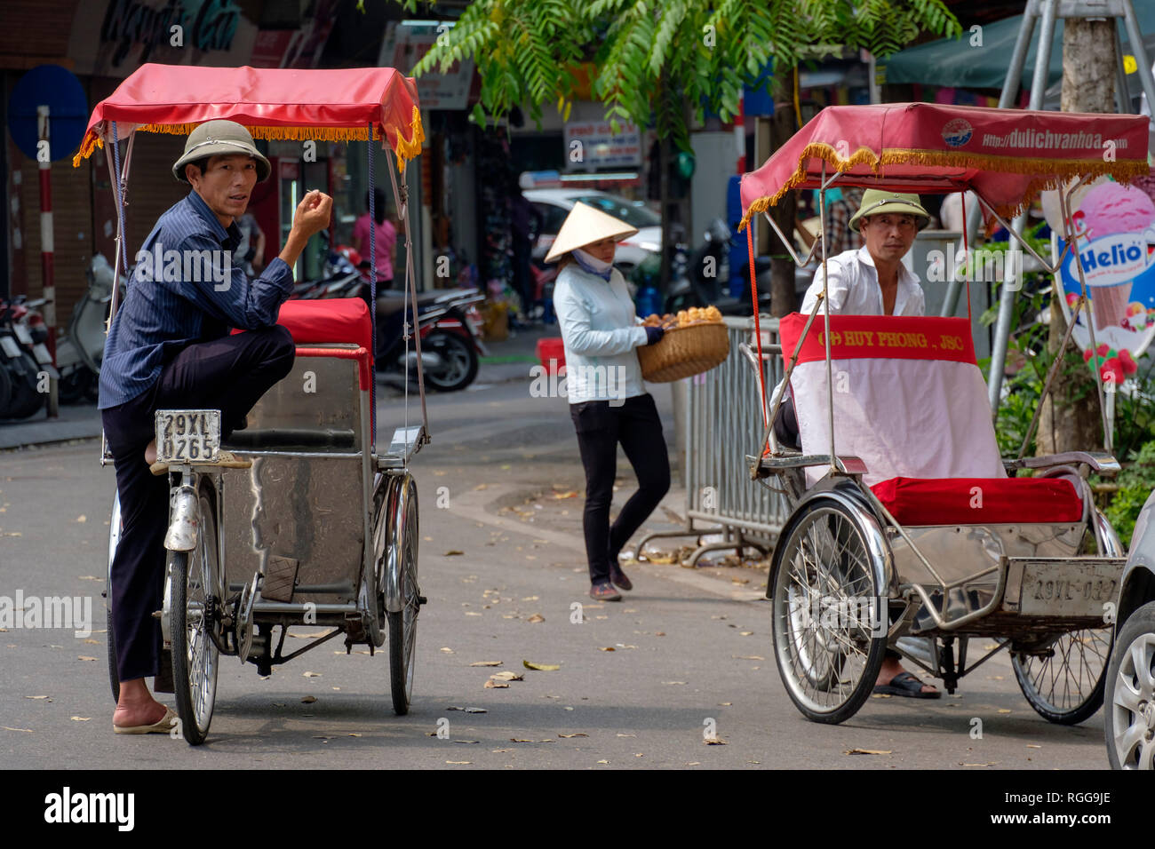 Rickshaw drivers waiting for tourists on the streets of Hanoi, VIetnam, Asia Stock Photo