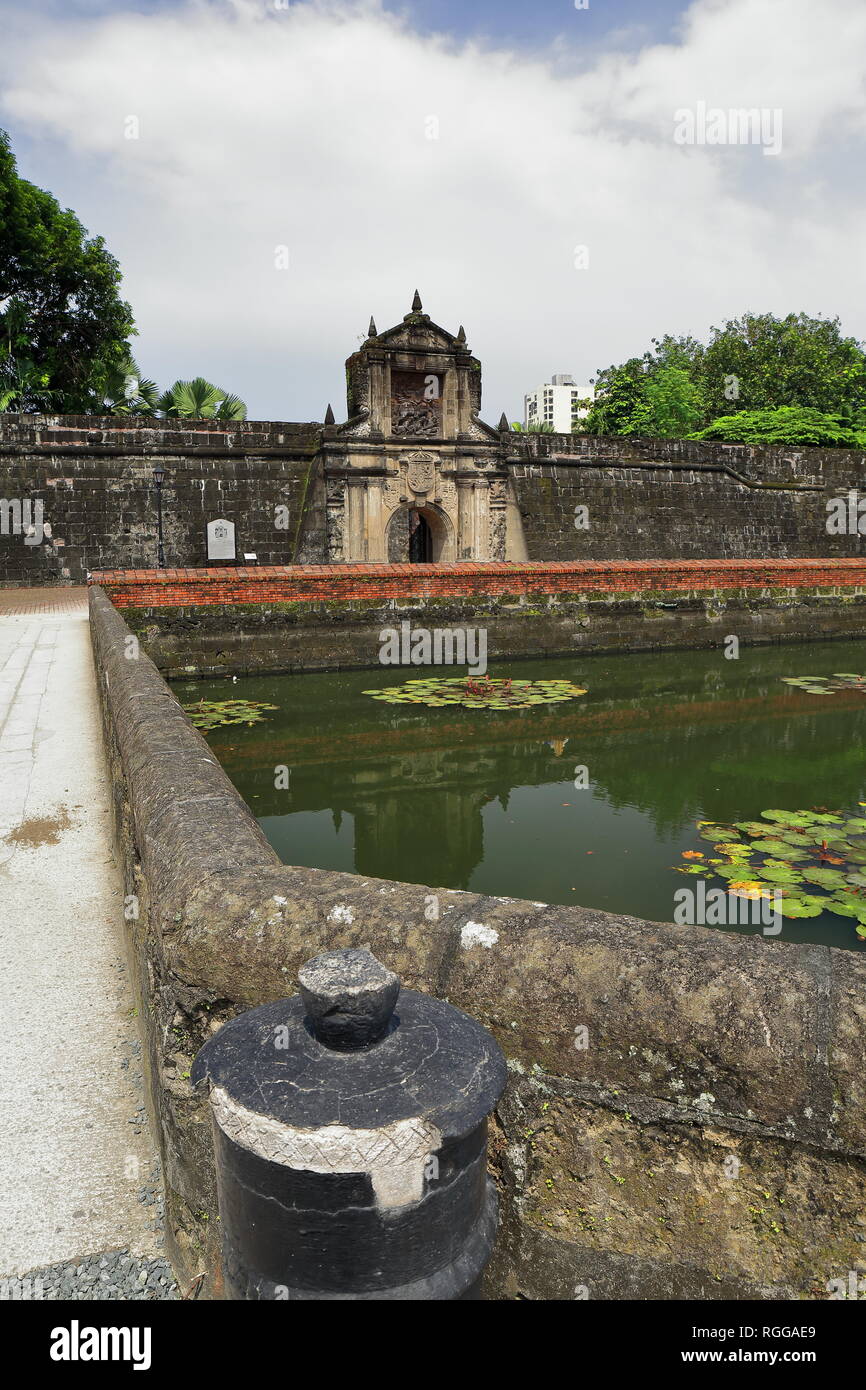 The 12 m.high main gate of Fort Santiago pierced in the south front of the curtain wall of the citadel seen across the moat separating it from the cit Stock Photo