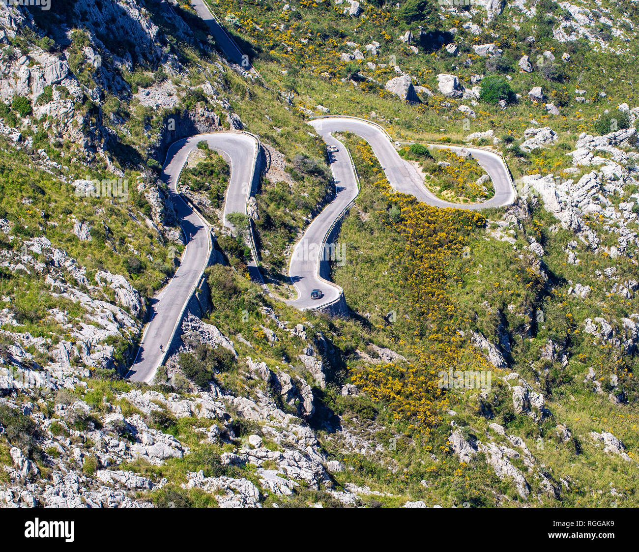 Cars driving popular among tourists beautiful winding mountain serpentine Coll dels Reis, Mallorca, Spain Stock Photo