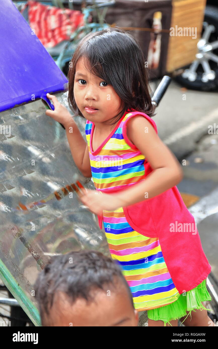 Manila, PhilippinesOctober 24, 2016 Filipino young girl takes care of