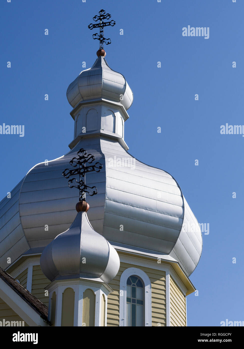 Onion Domes of the Church at the Ukranian Folk Museum: Two domes topped by eastern crosses decorate the roof of the church that is part of this heritage folk museum near Edmonton. Stock Photo