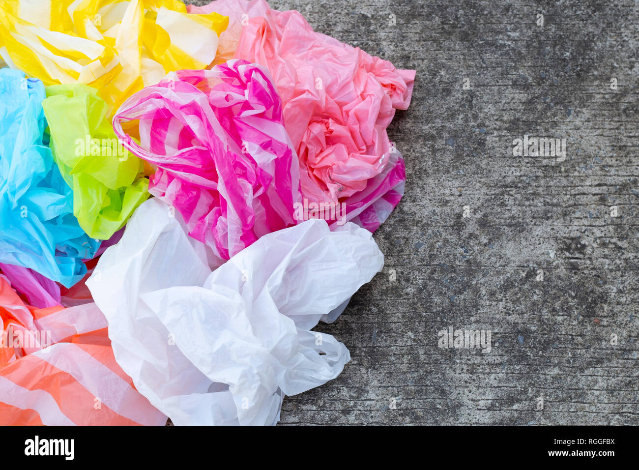 Colorful Disposable Plastic Bags On Cement Floor Stock Photo