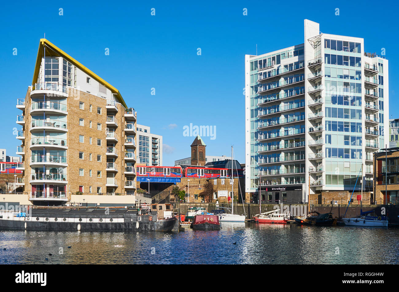 New apartments and the Docklands Light Railway at Limehouse Basin, East London, UK Stock Photo