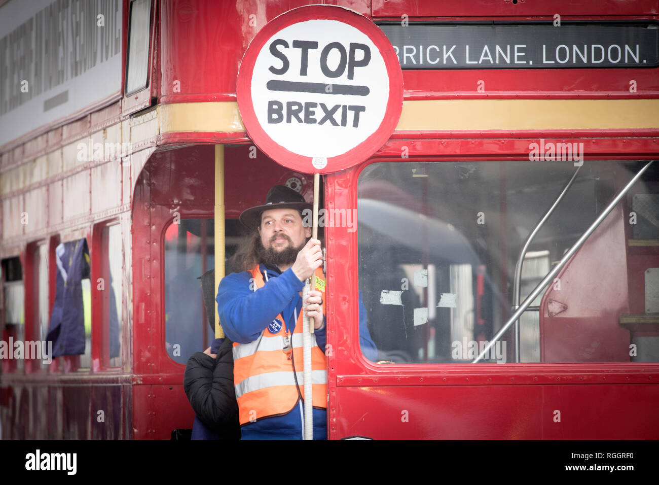 A man holds a 'Stop Brexit' sign aboard a campaign bus travelling down Whitehall in Westminster, London as a crucial debate on Brexit gets underway. Stock Photo