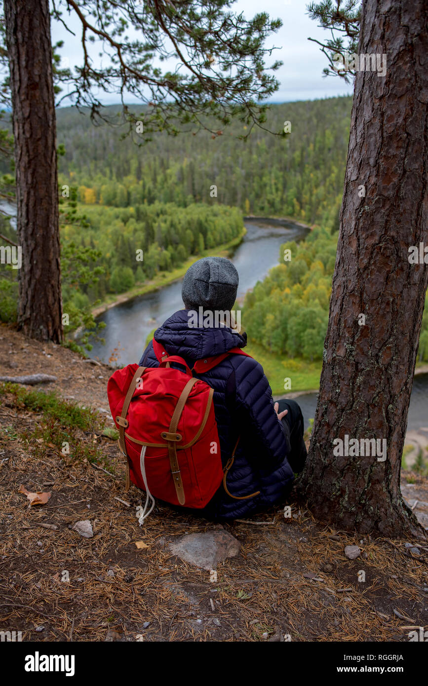 Finland, Oulanka National Park, woman with backpack sitting in pristine  nature Stock Photo - Alamy
