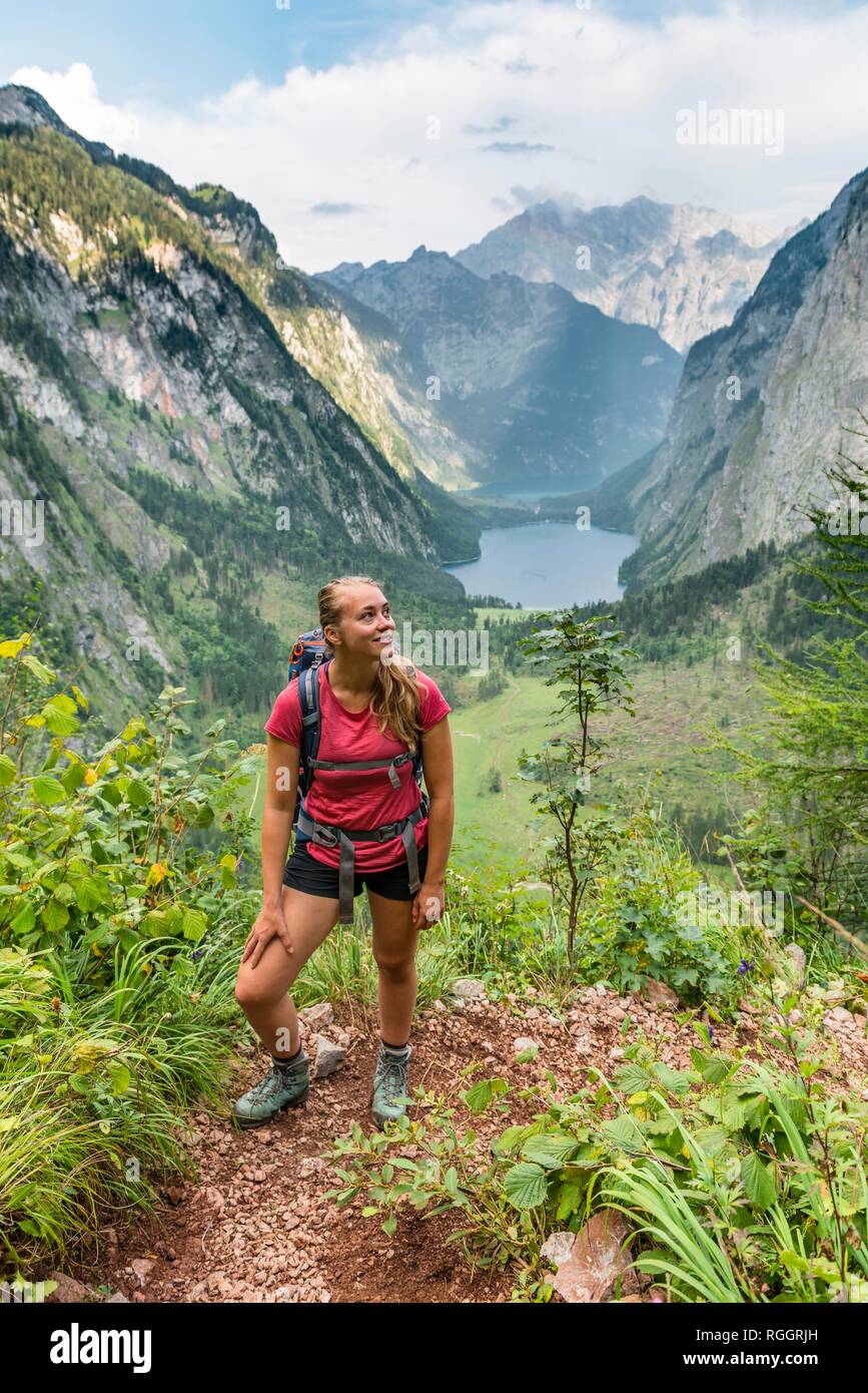 View of Obersee and Königssee, young hiker on the Röthsteig, behind Watzmann, Berchtesgaden, Upper Bavaria, Bavaria, Germany Stock Photo