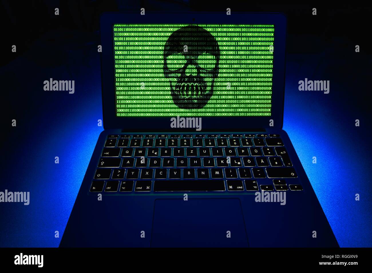 Laptop with skull and crossbones and binary numbers on screen, symbol image malware, virus alarm, computer crime Stock Photo