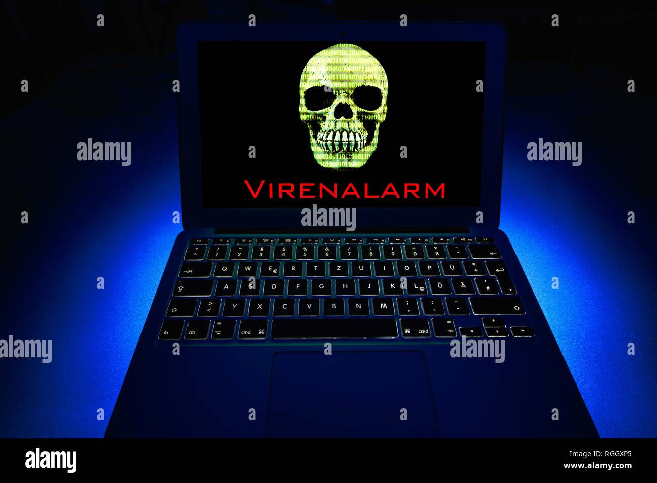 Laptop with skull and crossbones on screen, symbol image malware, virus alarm, computer crime, data protection Stock Photo