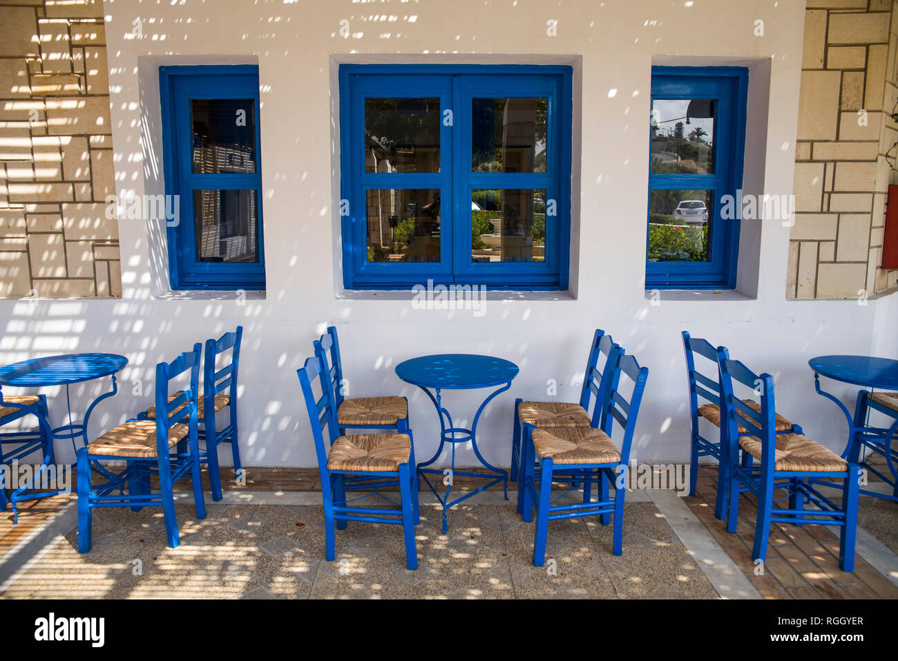 Blue chairs and tables in the restaurant. A place to eat on the seashore. Stock Photo