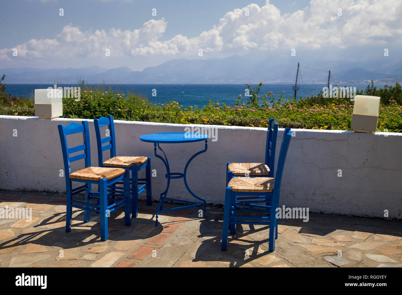 Blue chairs and tables in the restaurant. A place to eat on the seashore. Stock Photo