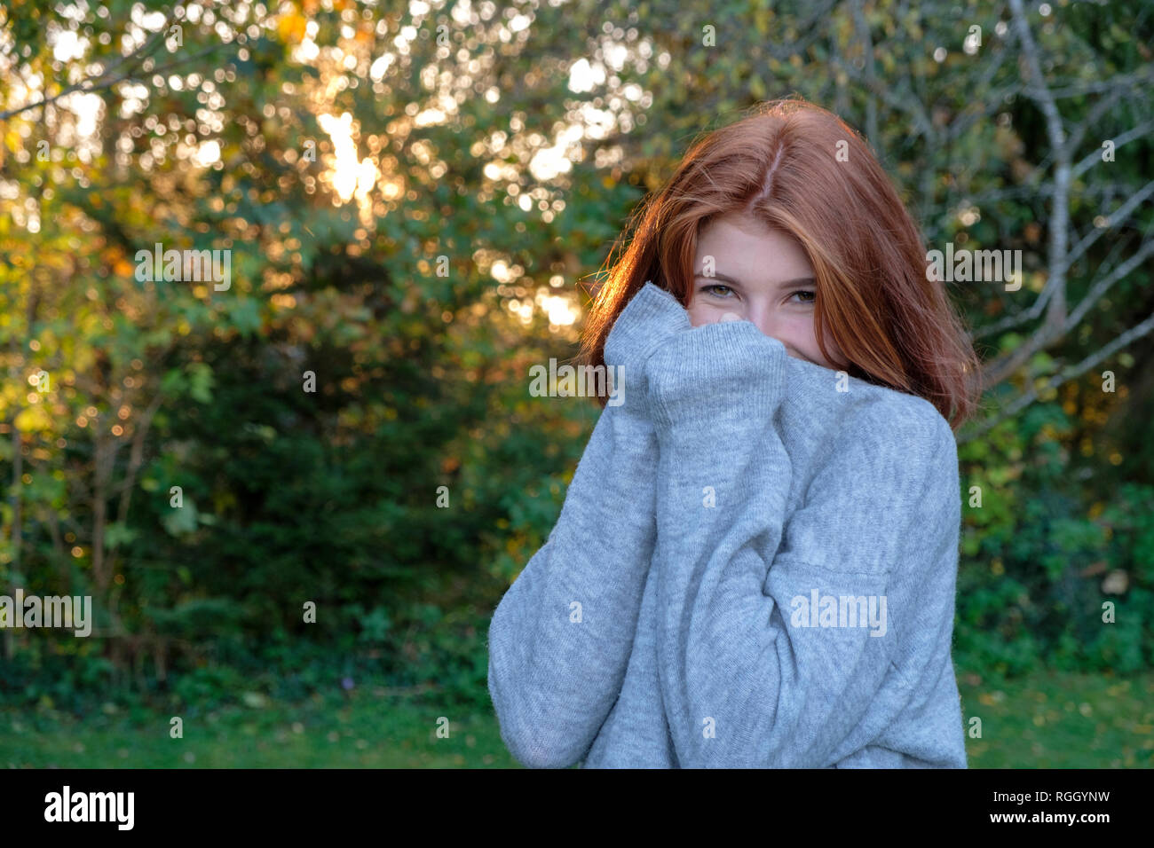 Portrait of teenage girl wearing grey pullover in autumn Stock Photo