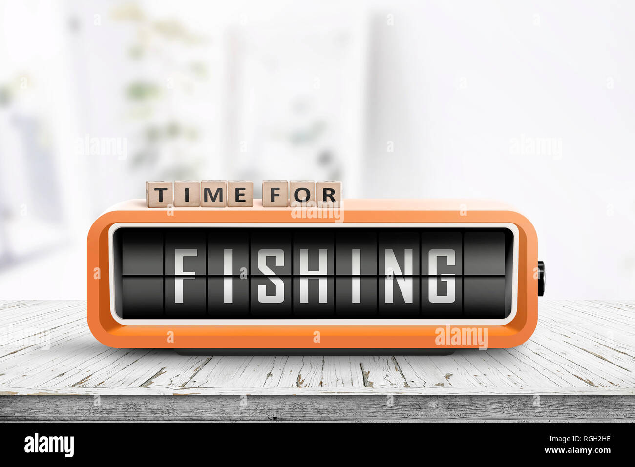 Retro alarm clock with the word fishing on a wooden table in a bright