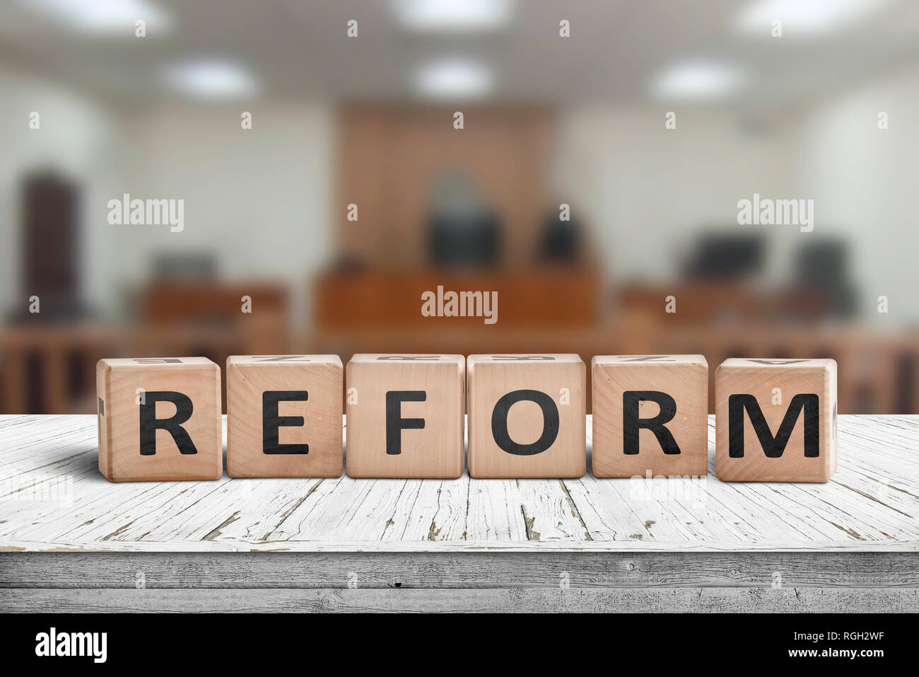 Reform sign on a desk with a blurry background of a court room Stock Photo