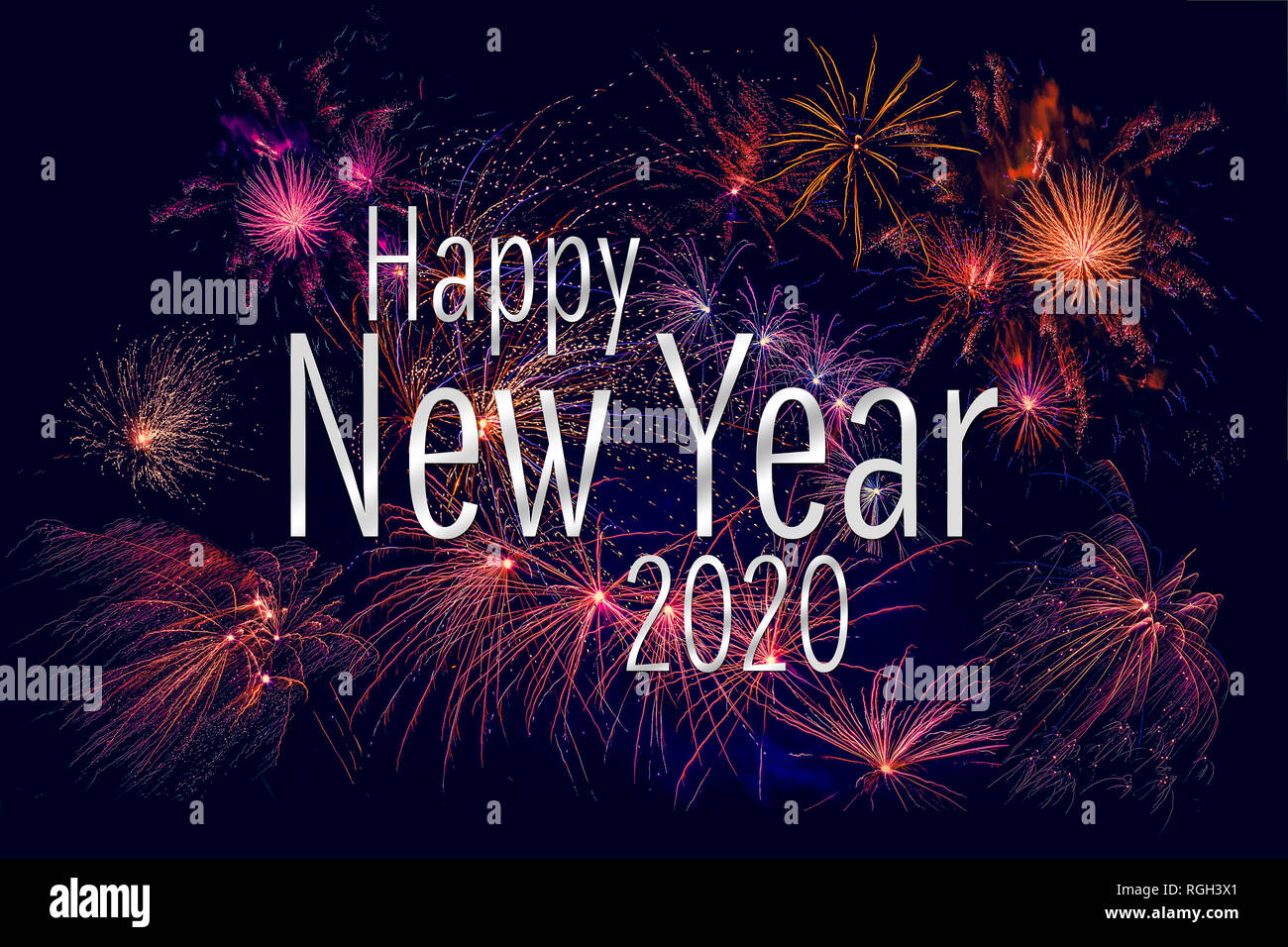 Happy New Year 2020 greeting with colorful fireworks in the night sky Stock Photo