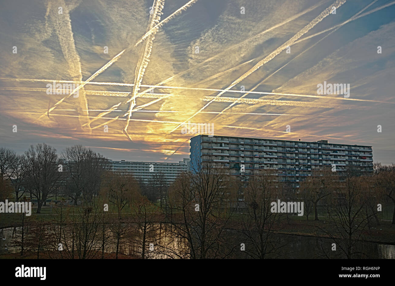 Chessboard sky, with the white vapor trails of plains coming from or going to nearby Schiphol airport. A fascinating pattern showing the 'airlines- cr Stock Photo