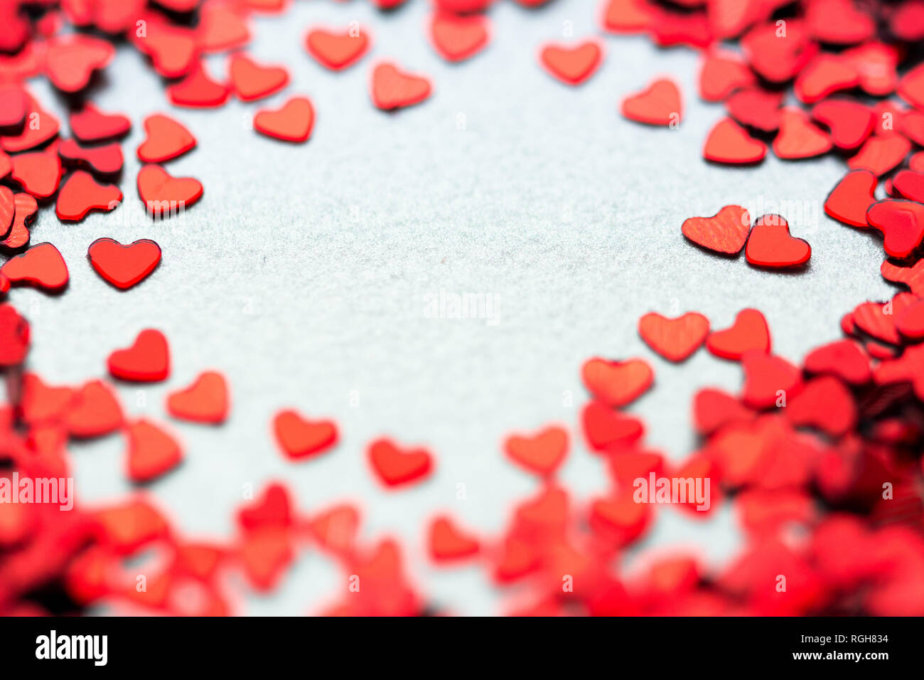 Valentine background with many red hearts around, couple of hearts together  and empty middle part Stock Photo - Alamy