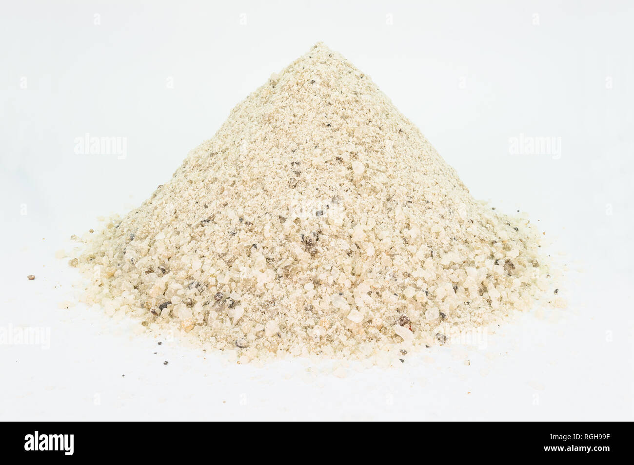 Heap of industrial salt to pour on the streets with medium grain, isolated on white. Stock Photo
