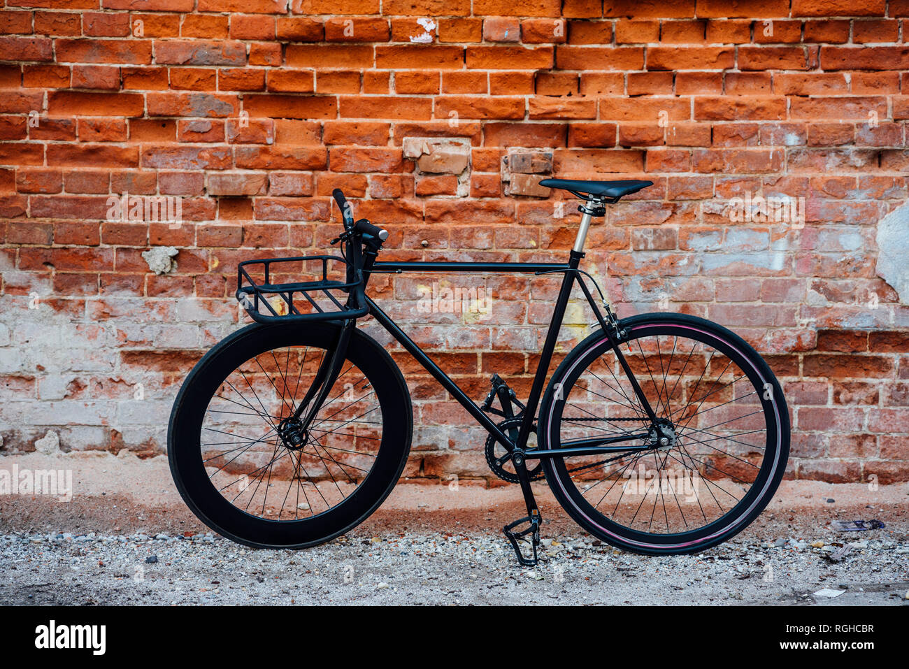 Customised commuter fixie bike at brick wall Stock Photo