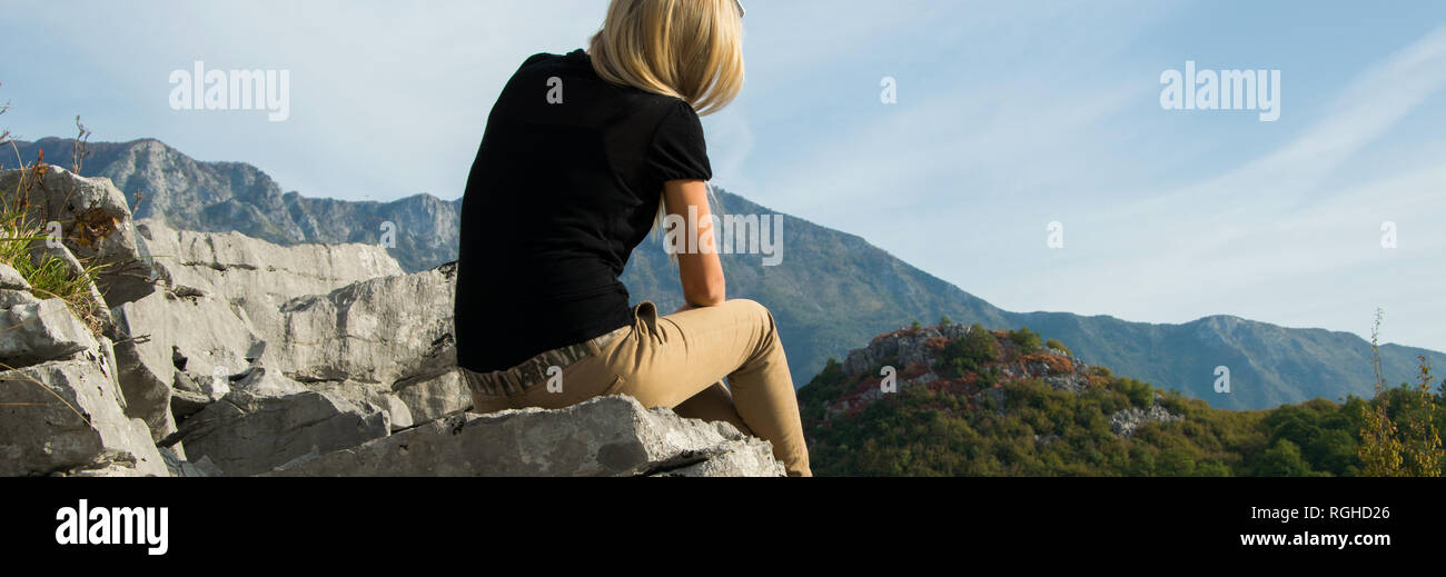 Girl Sitting On Edge Cliff High Resolution Stock Photography and Images