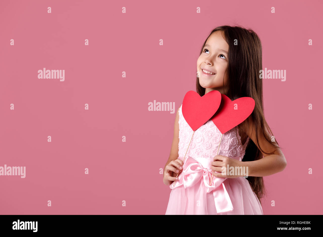 cute little girl in a pink dress holding a paper heart Stock Photo - Alamy