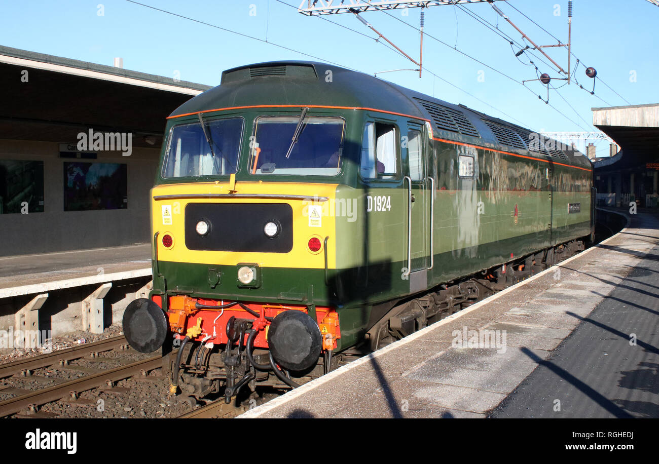 Class 47 diesel-electric locomotive, D1924, in two tone green livery passing through Carnforth station on a light engine movement on 28th January 2019 Stock Photo