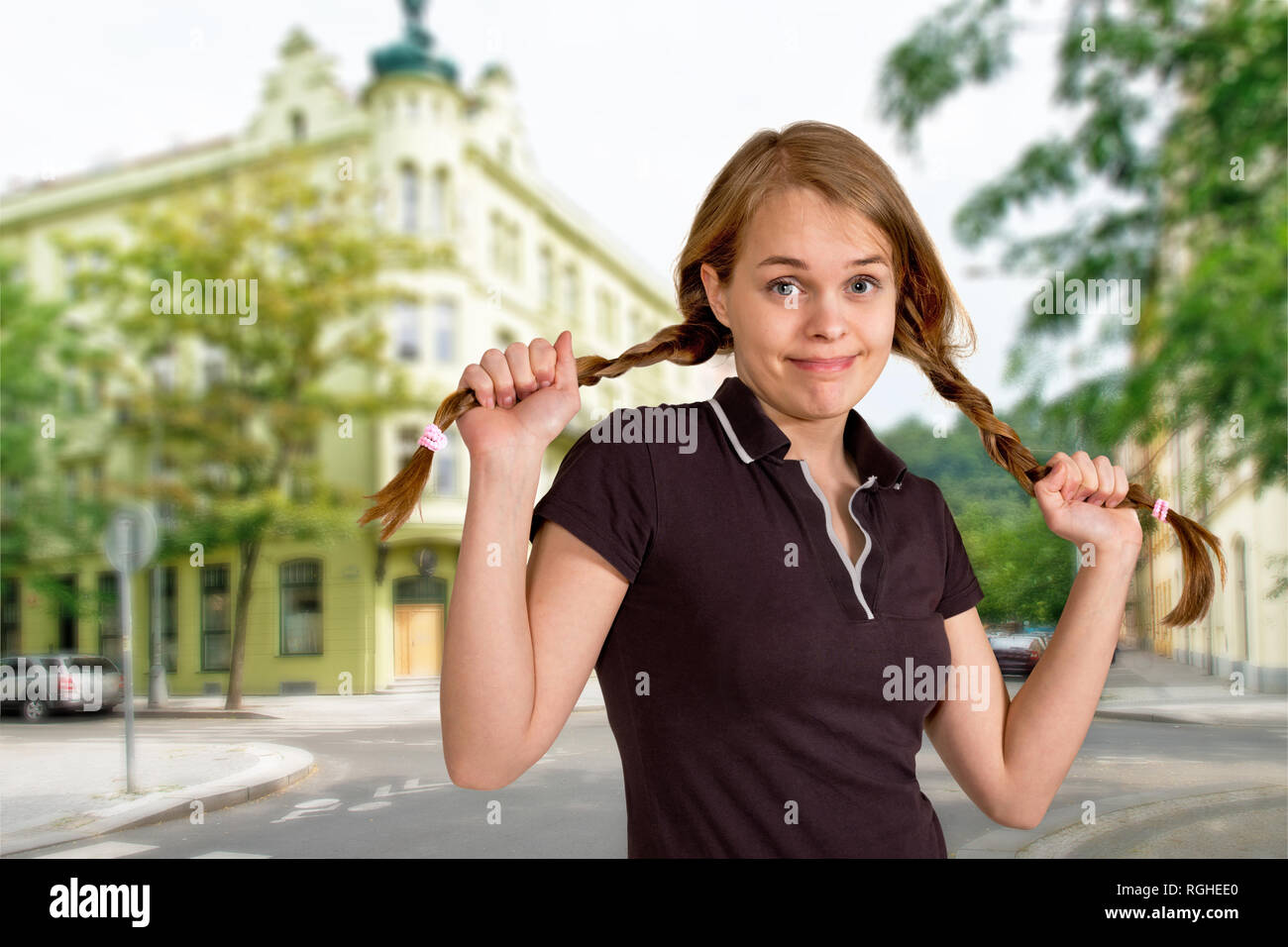 Portrait of embarrassed girl standing on a street Stock Photo - Alamy