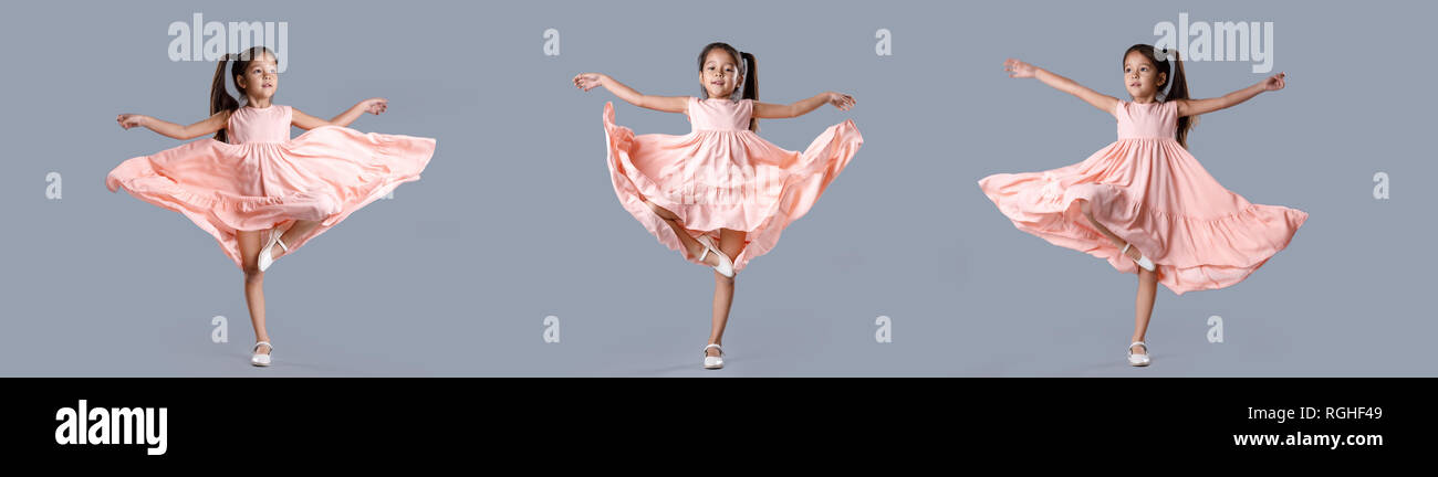 little girl in pink dress posing on gray background Stock Photo - Alamy