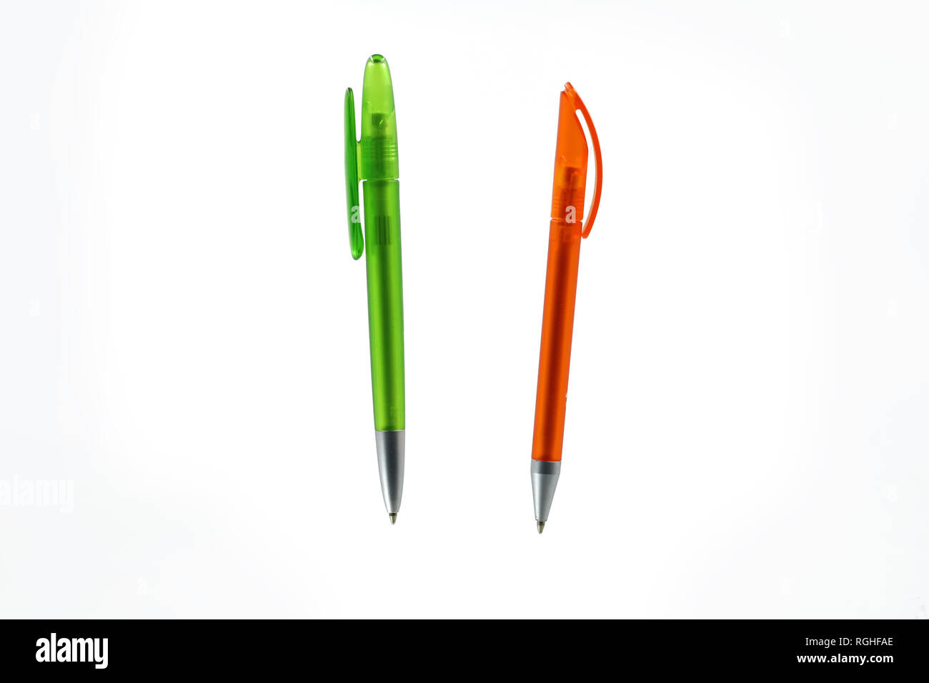 green and orange plastic ballpoint pen isolated on white background Stock Photo
