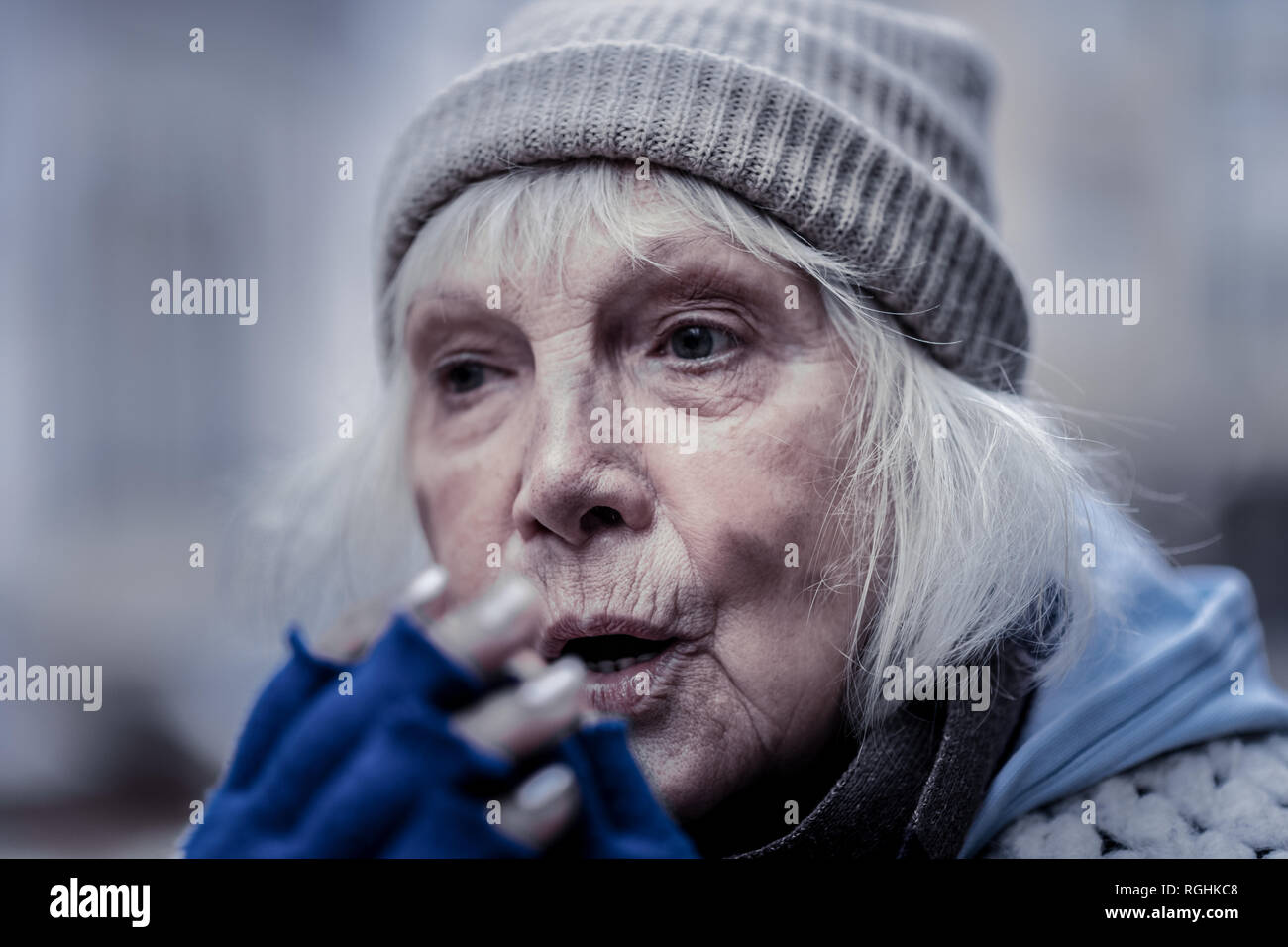 Portrait of a gloomy poor elderly woman Stock Photo