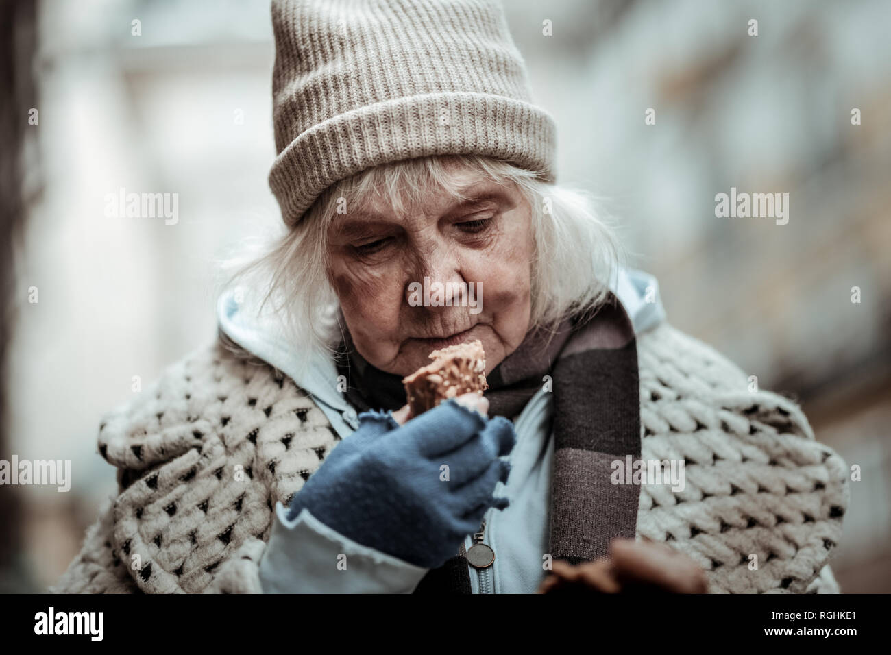 Nice aged woman looking at the bread Stock Photo