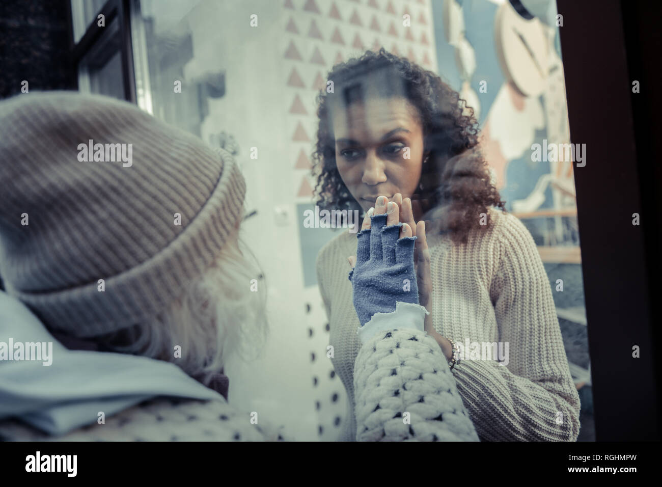 Nice young woman opening the door of cafeteria Stock Photo
