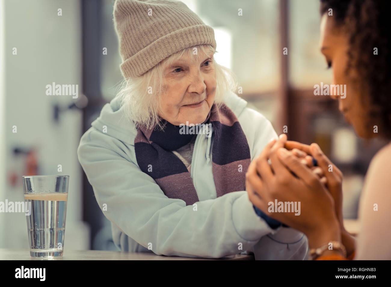 Tired aged woman looking at her helper Stock Photo
