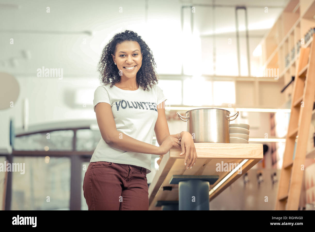 Delighted nice woman standing in the kitchen Stock Photo