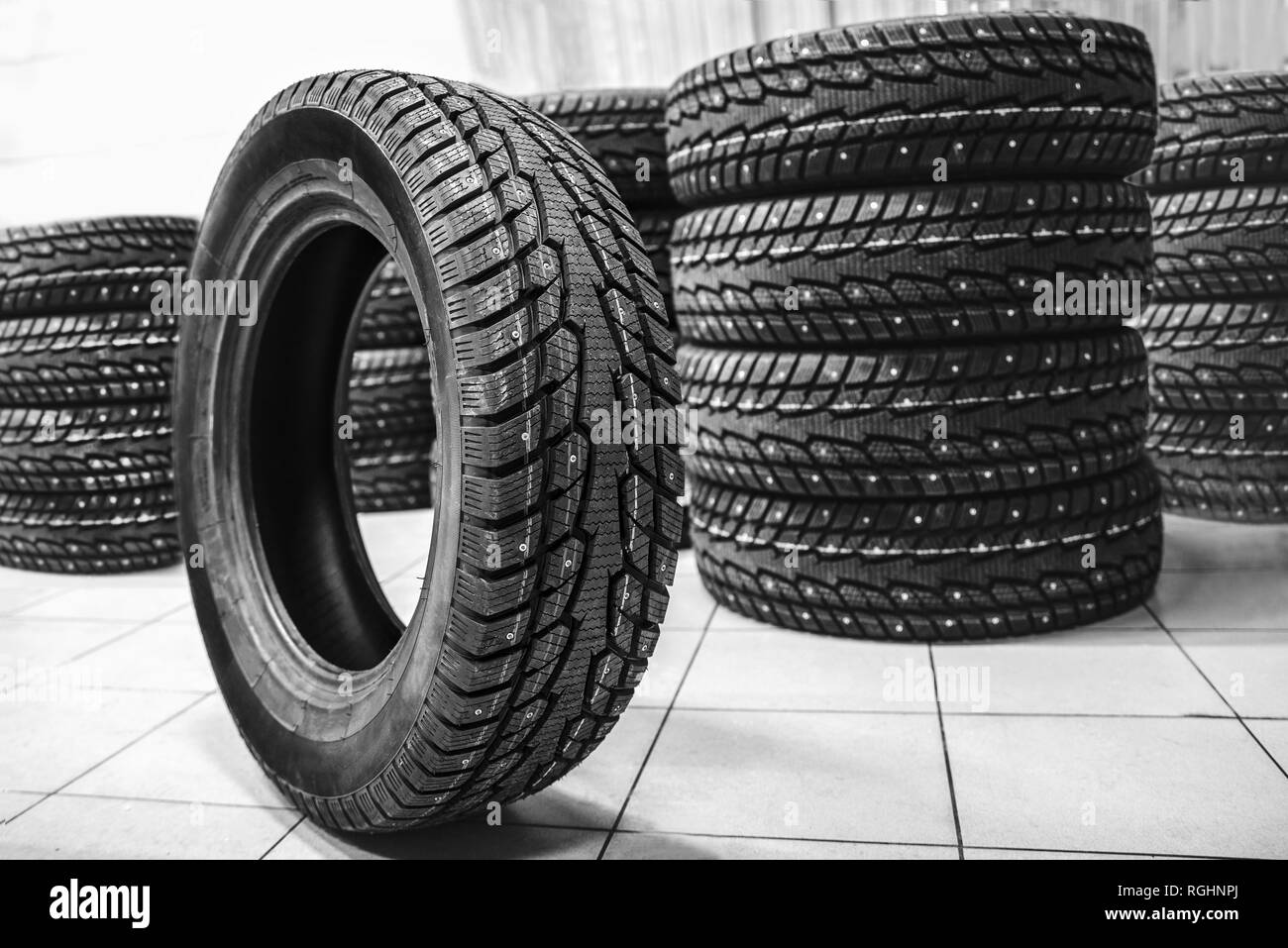 new car tire compared to other tires with a shallow depth of field